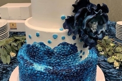 a sapphire cake with a gumpaste flower